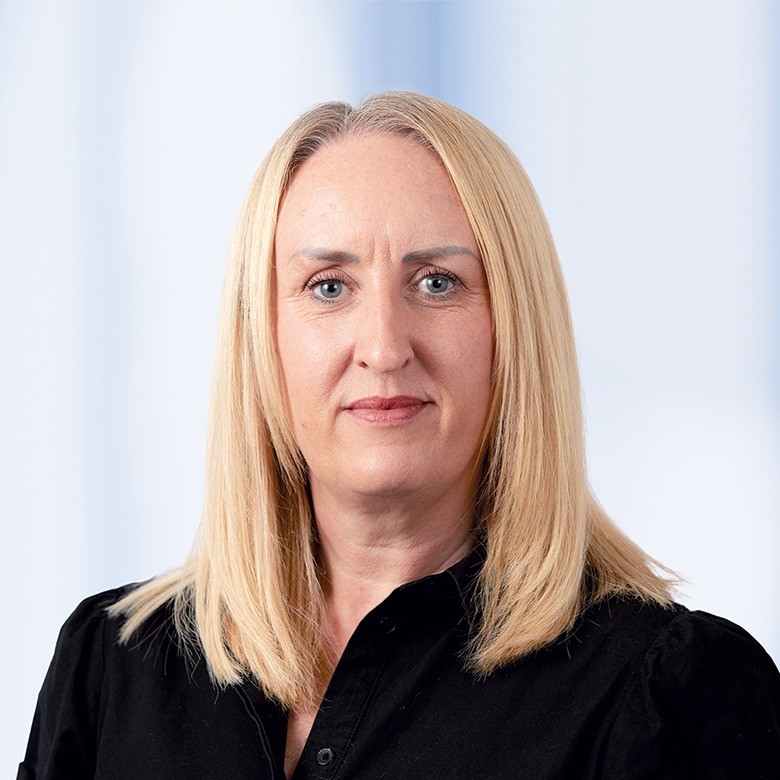 Headshot of in front of a white background.